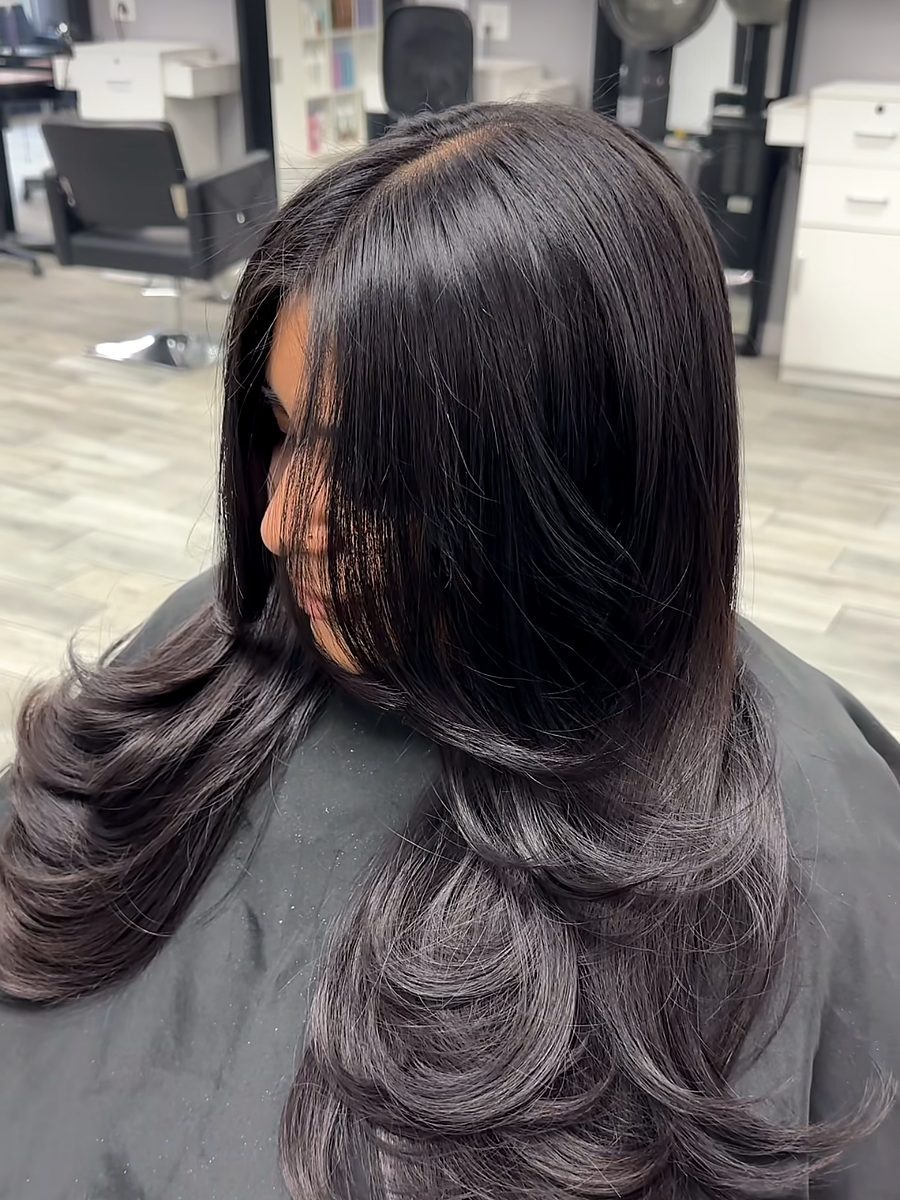 Long dark layered haircut with a smooth blowout
