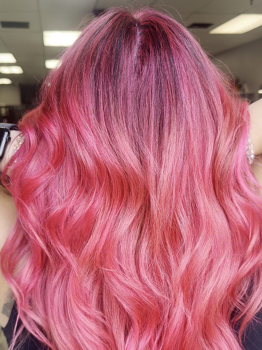 Long wavy hair in a bright vivid pink